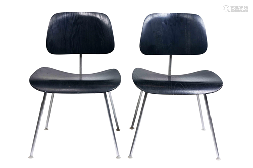 A pair of Charles and Ray Eames DCM chairs