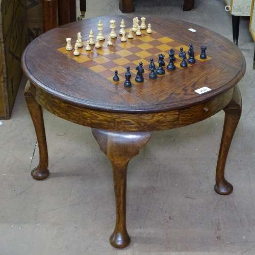 A 1930s circular oak games-top table on cabriole legs, complete with chess set, W16cm, H44cm