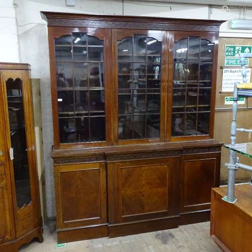 A mahogany 2-section library bookcase in Chippendale style, having 3 arched lattice glazed doors, on