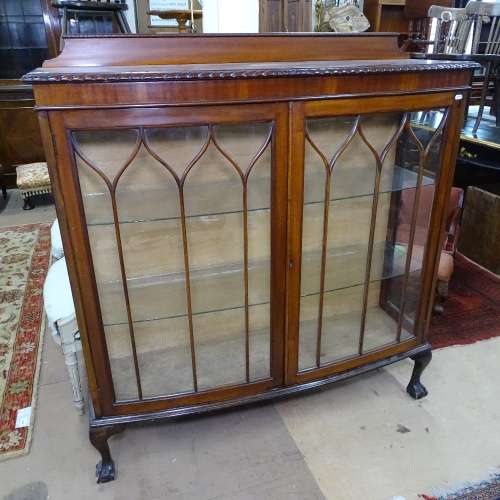 A 1930s mahogany bow-front display cabinet, 2 lattice glazed doors, on claw and ball feet, W123cm,