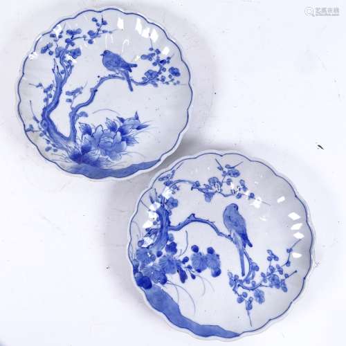 A pair of Japanese blue and white ceramic lobed plates, bird in tree decoration, diameter 22cm