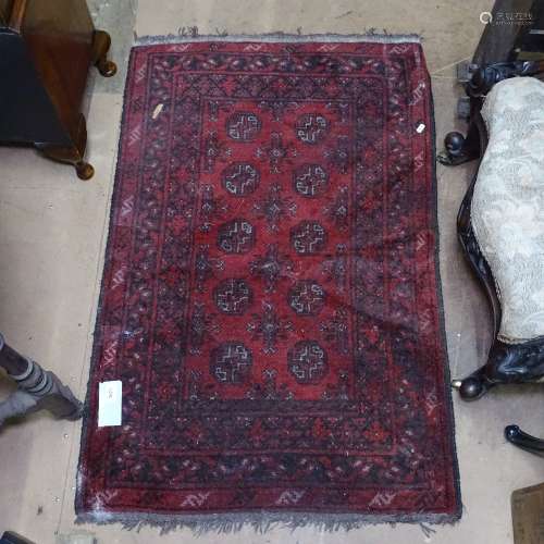 A red ground Afghan design rug, 120cm x 75cm