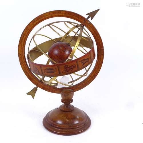 A table-top brass-mounted armillary sphere, with zodiac and turned wood base, height 35cm