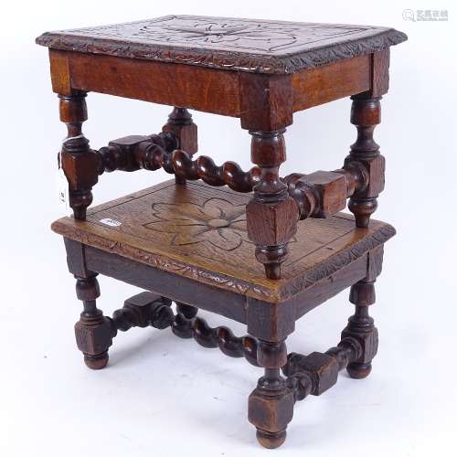 A pair of 19th century carved and stained oak low footstools, with floral decoration and barley