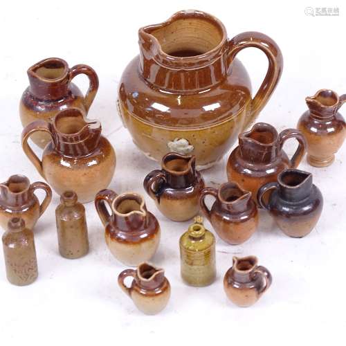 A group of miniature stoneware jugs and ginger beer bottles, including some Royal Doulton (15)
