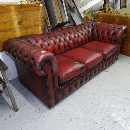 A red leather button-back upholstered 2-seater Chesterfield settee