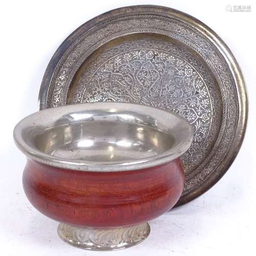 An Eastern unmarked white metal engraved dish, and a white metal-mounted turned wood bowl, largest