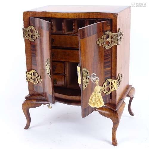 A miniature satinwood rosewood and walnut apprentice piece serpentine-front cabinet on stand,