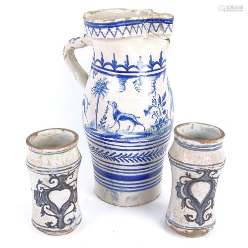 A large Spanish blue and white glazed pottery water flagon, and a pair of Dutch pottery beakers,