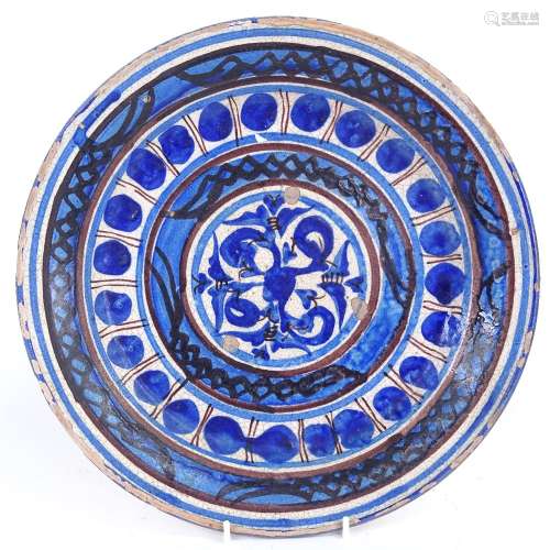 A 19th century European pottery charger, blue and white glaze decoration, diameter 32cm