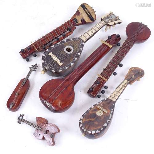 A group of miniature mother-of-pearl tortoiseshell and wood mandolins, largest length 17cm (7)