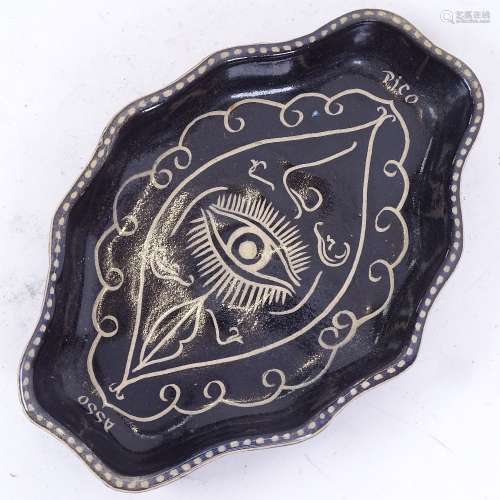 A Studio pottery black and white earthenware dish, in the style of Pablo Picasso, facial feature