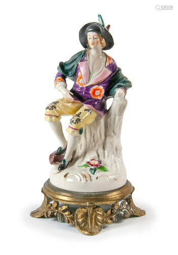 PORCELAIN FIGURE OF SEATED MAN