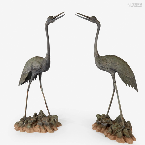 A pair of very large well-modeled bronze cranes on