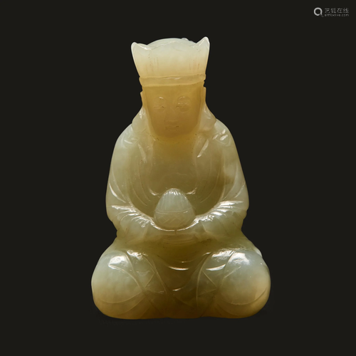 A small Chinese carved pale celadon jade figure of a