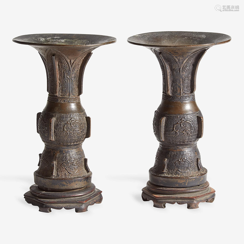 A pair of small Chinese patinated bronze gu-form vases,