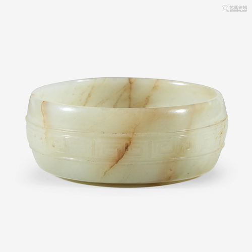 A Chinese pale celadon and russet jade circular coupe,