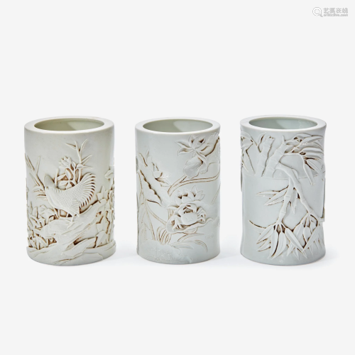 Three Chinese molded and carved porcelain brushpots,