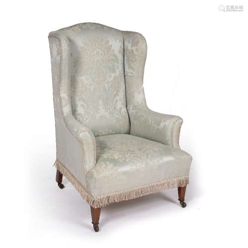 Mahogany framed wingback armchair on short square supports with original castors, 116cm high, 77cm