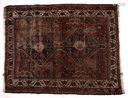 Persian red ground rug with joined central double medallion and with foliate border, 146cm x 112cm