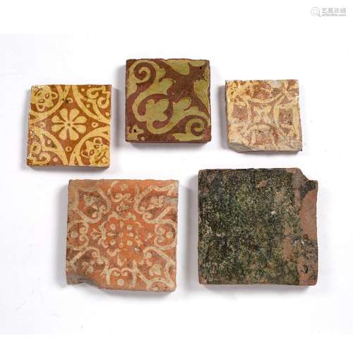 Five medieval tiles 14th/15th century, on a terracotta ground, of varying designs, largest 18cm