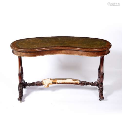 Kidney shaped desk with leather inset top Victorian, walnut, the stretcher with a padded footrest,