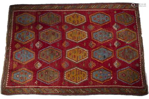 Kelim carpet of red ground with typical red and green stylised panels, 216cm x 343cm