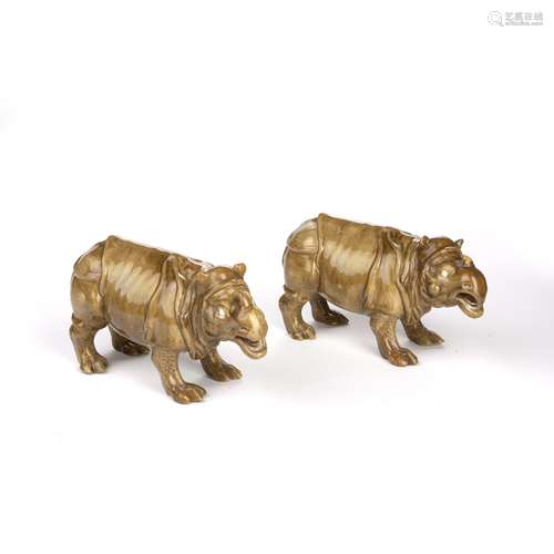 Two Royal Worcester models of a rhinoceros impressed factory marks, glazed in olive-coloured