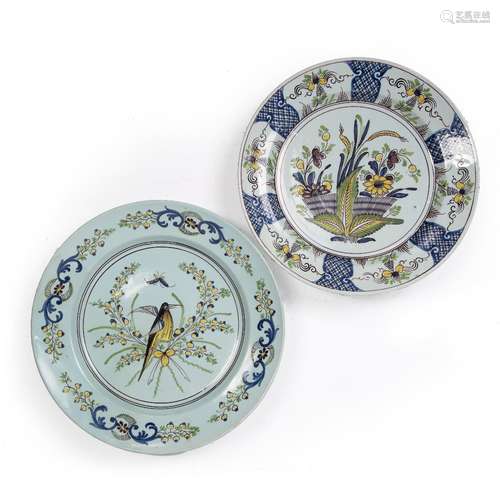 Two Delftware polychrome chargers circa 1740, one painted with a bird and butterfly, 35cm and the