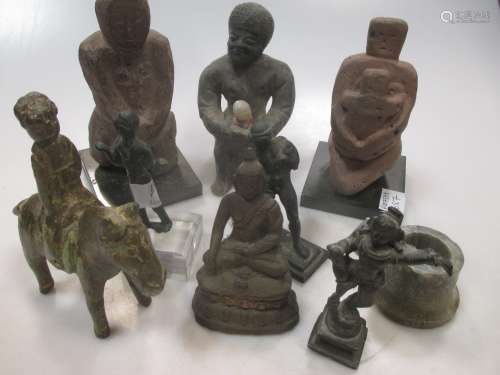 A group of various carved stone and wood figures and objects