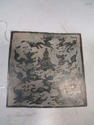 An East Asian stone panel decorated with a central seated Buddha surrounded by nine short bodied