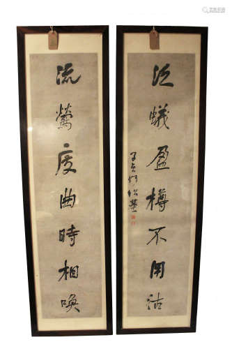 Two Chinese calligraphic hanging scrolls, ink on paper, stamped red seals, framed, 134x 32cm