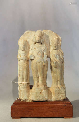 A Chinese green stone Buddhist triad group, in 6th/7th century style, 20.5cm high