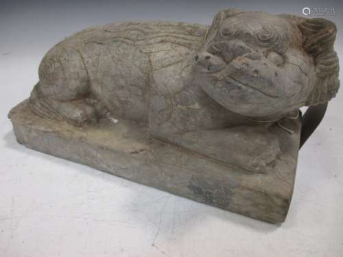 A Chinese carved limestone recumbent fo-dog, in Ming style, with well detailed face and mane, 30 x