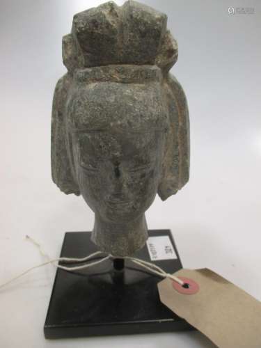 A grey stone head of a Bodhisattva, 11cm high (14cm high to include the stand)