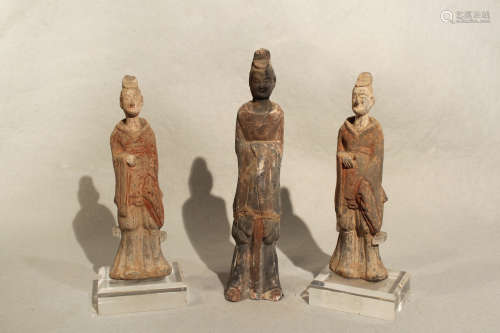 Three Chinese pottery figures of standing attendants/entertainers, perhaps Sui Dynasty, tallest 24cm