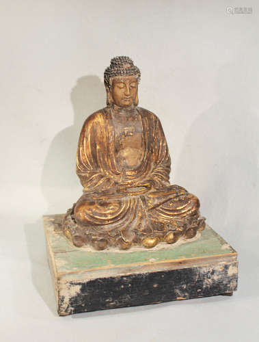 A Chinese gilded pottery seated Buddha in meditation on lotus dais, on wood stand, perhaps c1900