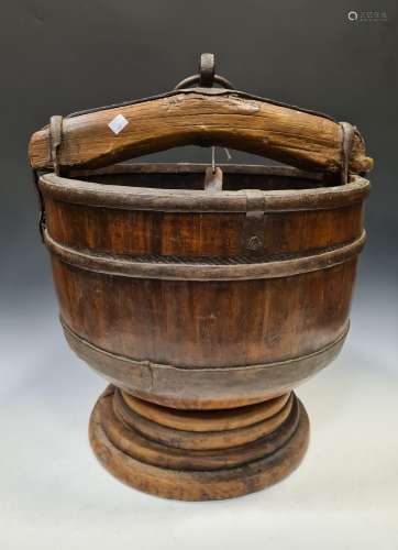 A Chinese carved wood and metal mounted well bucket, 19/early 20th century