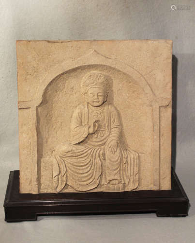 A Chinese red pottery panel in relief with seated Bodhisattva, within an arch, in 6th-7th century