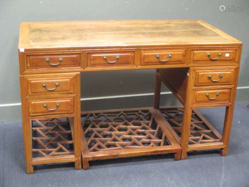 A Chinese twin pedestal desk, 20th century, with a row of frieze drawers, and three drawers to