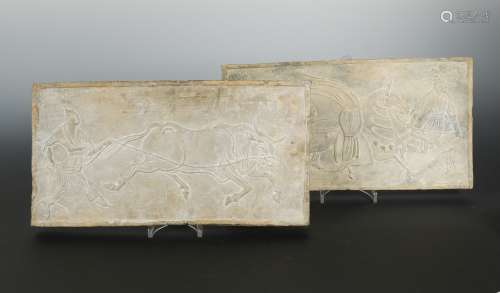A pair of Chinese grey pottery relief tiles, perhaps Han Dynasty, depicting figures with bull and