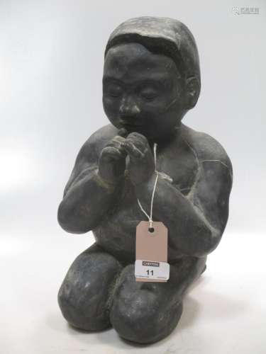 A Chinese black glazed porcellanous figure of a kneeling boy child, 20th century, 35cm high