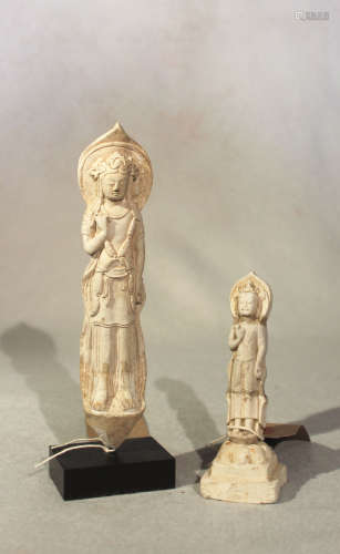 A Chinese stucco figure of Guanyin standing, 19cm high, and another, 12cm high, both in 6th