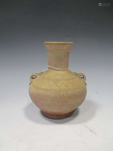 A Chinese olive glazed pottery Hu jar, Han Dynasty, with shoulder lugs and line incised detail, 15cm