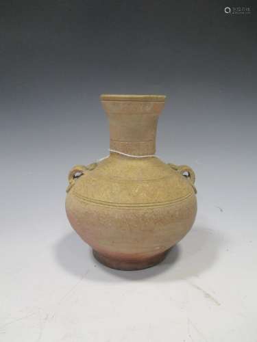 A Chinese olive glazed pottery Hu jar, Han Dynasty, with shoulder lugs and line incised detail, 15cm