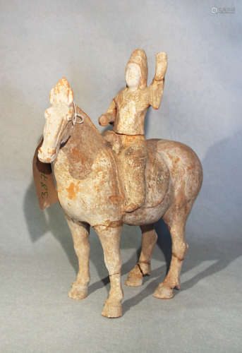 A Chinese red pottery horse with rider up, Han Dynasty type, 31.5cm high