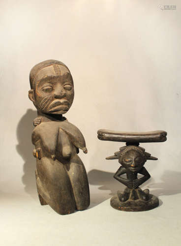 A Baluba wood headrest, with stylized kneeling figure with stepped fan coiffure, 21cm high; an Ibo