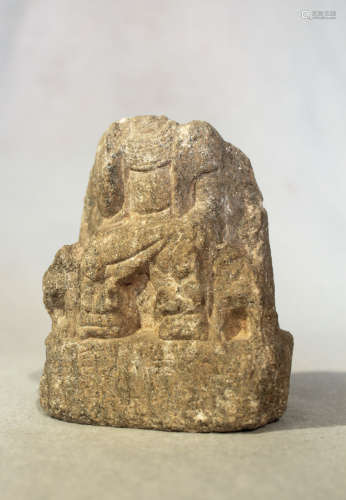 A Chinese grey flecked stone fragmentary figure of a seated Buddhist deity, in late Wei Dynasty