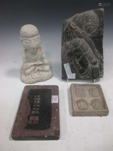 A Chinese carved black stone plaque, in Ming Style, carved in relief with a Bodhisatvva head, 19.5cm