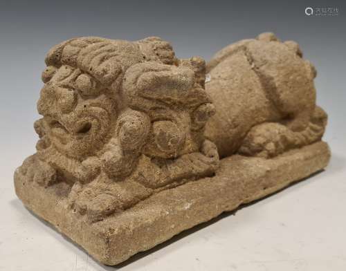 A Chinese carved grey- stone crouched Fo dog, perhaps 19th century, on integral plinth, 11 x 22cm